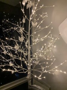 white tree with tiny white lights on the branches