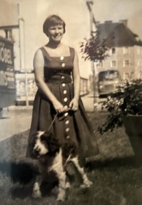 An old photo of Dagmar's sister Uzi on a city street walking her dog.